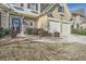 Close-up of a home featuring stone accents, a two-car garage, and landscaped yard at 2331 Flowerdale Ct, Douglasville, GA 30135