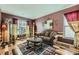 Cozy living room featuring hardwood floors, burgundy walls, and natural light at 2331 Flowerdale Ct, Douglasville, GA 30135
