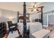 Well-appointed main bedroom with a four-poster bed, elegant furniture, and a ceiling fan at 2331 Flowerdale Ct, Douglasville, GA 30135
