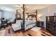 Well-appointed main bedroom with a four-poster bed, elegant furniture, and a ceiling fan at 2331 Flowerdale Ct, Douglasville, GA 30135