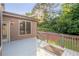 Wooden back deck offering ample space and serene views of lush greenery and landscaping at 2604 Heltonwood Ct, Buford, GA 30519