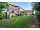 Grassy backyard featuring a multi-level deck, beautiful landscaping, and brick accents at 2604 Heltonwood Ct, Buford, GA 30519