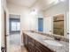 Bathroom vanity with double sinks, granite countertop, and view to the bedroom and shower at 2604 Heltonwood Ct, Buford, GA 30519