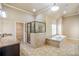 Bathroom featuring a soaking tub, glass shower, granite counters and tile floors at 2604 Heltonwood Ct, Buford, GA 30519