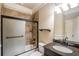 Bathroom featuring tile surround shower/tub combo and granite vanity with sink at 2604 Heltonwood Ct, Buford, GA 30519