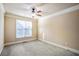 Neutral bedroom with wall-to-wall carpeting and large window providing natural light at 2604 Heltonwood Ct, Buford, GA 30519