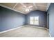 Bedroom featuring neutral carpet, gray walls, trey ceiling, ceiling fan, and natural light from a window at 2604 Heltonwood Ct, Buford, GA 30519