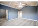 Spacious bedroom with blue walls, a coffered ceiling, and plush gray carpeting at 2604 Heltonwood Ct, Buford, GA 30519