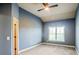 Cozy bedroom with a gray walls, plush neutral carpet, a ceiling fan, and natural light from a window at 2604 Heltonwood Ct, Buford, GA 30519