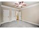 Bedroom with neutral carpet, two closets, and an open doorway to another room at 2604 Heltonwood Ct, Buford, GA 30519