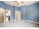 Bedroom with neutral carpet, blue walls and trim, and doors leading to a bathroom and hallway at 2604 Heltonwood Ct, Buford, GA 30519