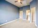 Spacious bedroom featuring gray walls, neutral carpet, and multiple doorways leading to different rooms at 2604 Heltonwood Ct, Buford, GA 30519