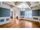 Elegant dining room with beautiful hardwood floors, coffered ceilings, large windows, and wood trim accents at 2604 Heltonwood Ct, Buford, GA 30519