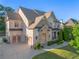 An inviting two-story brick home featuring a two-car garage and well-manicured landscaping at 2604 Heltonwood Ct, Buford, GA 30519