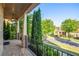 Charming brick front porch with black railings and views of the manicured neighborhood at 2604 Heltonwood Ct, Buford, GA 30519