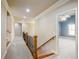 Hallway with wrought iron railing leading to a bedroom with tray ceiling at 2604 Heltonwood Ct, Buford, GA 30519