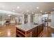 Beautiful kitchen with stainless steel appliances and large island opens to a living area with fireplace at 2604 Heltonwood Ct, Buford, GA 30519