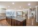 Gourmet kitchen with granite countertops and large island opens to a spacious living area with fireplace at 2604 Heltonwood Ct, Buford, GA 30519