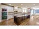 Bright kitchen with stainless steel double oven, custom cabinets, and island with wine rack at 2604 Heltonwood Ct, Buford, GA 30519