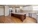 Spacious kitchen with a large island, stainless steel appliances, granite countertops, and custom cabinets at 2604 Heltonwood Ct, Buford, GA 30519