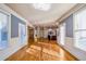 Large living room with wood floors, natural light, and doors leading to a deck or patio at 2604 Heltonwood Ct, Buford, GA 30519