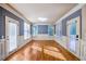Sun-filled living room with multiple windows, wood floors and doors leading to a deck or patio at 2604 Heltonwood Ct, Buford, GA 30519