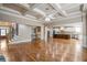 Expansive living area showcasing hardwood floors, coffered ceilings, access to the kitchen, staircase, and main entrance at 2604 Heltonwood Ct, Buford, GA 30519