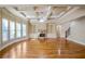 Large living room with stone fireplace, coffered ceiling, hardwood floors, and an abundance of natural light at 2604 Heltonwood Ct, Buford, GA 30519
