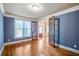 Bright living room featuring hardwood floors, transom windows, and an entry to the main hall with gorgeous glass paned doors at 2604 Heltonwood Ct, Buford, GA 30519