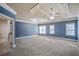 Large main bedroom with tray ceiling, carpet, and ample natural light from several windows at 2604 Heltonwood Ct, Buford, GA 30519