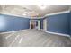 A spacious bedroom boasting blue walls, neutral carpet, and elegant tray ceiling at 2604 Heltonwood Ct, Buford, GA 30519