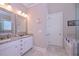Bathroom featuring a double vanity with framed mirrors and a walk-in shower at 295 Hanover Dr, Villa Rica, GA 30180