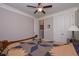 Bright bedroom featuring a ceiling fan, and large closets with bi-fold doors at 295 Hanover Dr, Villa Rica, GA 30180