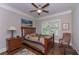 Serene bedroom featuring a wooden bed frame, dresser, bedside table, and a view of the outside at 295 Hanover Dr, Villa Rica, GA 30180