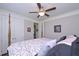 Bedroom featuring a four poster bed, closet, and a ceiling fan at 295 Hanover Dr, Villa Rica, GA 30180