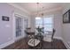 Bright breakfast nook features a glass-top table, seating for four, and sliding door access to the backyard at 295 Hanover Dr, Villa Rica, GA 30180