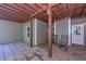 View of a covered patio space with gray siding, a stone floor, and rocking chairs at 295 Hanover Dr, Villa Rica, GA 30180