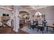 A formal dining room featuring hardwood floors, elegant lighting, and an open floor plan at 295 Hanover Dr, Villa Rica, GA 30180