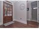 Elegant foyer with hardwood floors, a wooden front door and a view of the bathroom at 295 Hanover Dr, Villa Rica, GA 30180