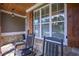 Inviting front porch with stone accents, rocking chairs, and a welcome sign at 295 Hanover Dr, Villa Rica, GA 30180