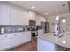 Modern kitchen featuring white cabinets, granite countertops, stainless steel appliances, and hardwood floors for an exquisite touch at 295 Hanover Dr, Villa Rica, GA 30180