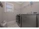 Laundry room equipped with a front load washer and dryer and wire shelving at 295 Hanover Dr, Villa Rica, GA 30180