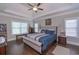 Spacious main bedroom features a trey ceiling, a large window for natural light, and warm hardwood floors at 295 Hanover Dr, Villa Rica, GA 30180