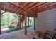 Outdoor patio area under deck with stone tiles, plants, and stairs to wooden deck at 295 Hanover Dr, Villa Rica, GA 30180