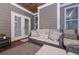 Cozy screened porch with ample seating and an inviting outdoor living space at 295 Hanover Dr, Villa Rica, GA 30180
