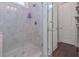 Walk-in shower with gray tile and a glass door, providing a luxurious bathing experience at 295 Hanover Dr, Villa Rica, GA 30180