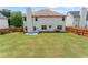 Spacious backyard with a lush lawn, wooden fence, and a patio, offering ample space for outdoor activities at 507 Vaughan Dr, Hampton, GA 30228