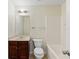 Bright bathroom featuring a bathtub and a vanity with a dark wood finish at 507 Vaughan Dr, Hampton, GA 30228