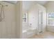 Large bathroom with natural light, shower, and tiled floors at 507 Vaughan Dr, Hampton, GA 30228