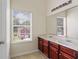 Bright bathroom with double sink vanity and large mirror over the two sinks and a window that allows natural light at 507 Vaughan Dr, Hampton, GA 30228